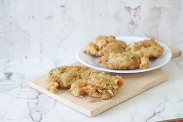 Bakwan goreng, fried food, Indonesian traditional street food snacks. fried vegetables dough fritters, appetizer on a white plate