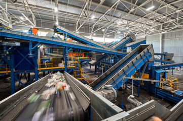 Conveyor carries trash pieces in recycling plant workshop
