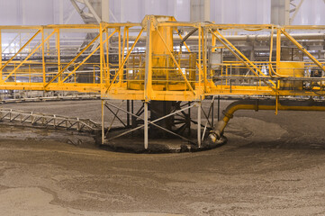 Large round floatation machine tank full of liquid at plant