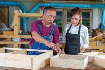 Tutor With Female Carpentry Student In Workshop Studying For Apprenticeship At College ,Teacher...