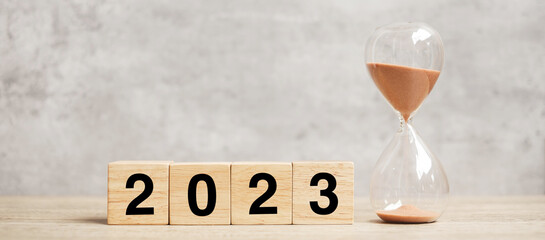 2023 text with hourglass on table. Resolution, time, plan, goal, motivation, reboot, countdown  and...