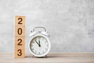 Happy New Year with vintage alarm clock and 2023 block. Christmas, New Start, Resolution, countdown, Goals, Plan, Action and Motivation Concept