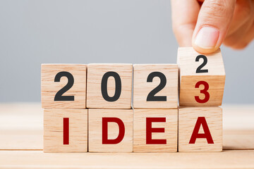 hand flipping block 2022 to 2023 IDEA text on table. goal, Resolution, strategy, plan, motivation, reboot, business and New Year holiday concepts