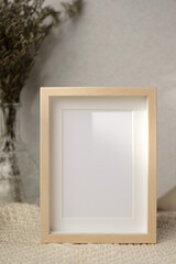 mockup photo frame with flower in vase on white soft wicker tablecloth