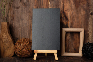 mockup blackboard with wood photo frame and wicker ball on table