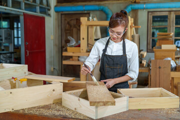 portrait of beautiful asian woman carpenter dealing with handicraft, woman has own business...