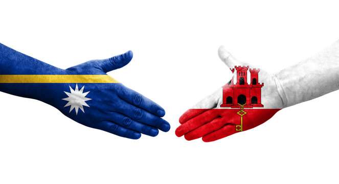 Handshake between Gibraltar and Nauru flags painted on hands, isolated transparent image.