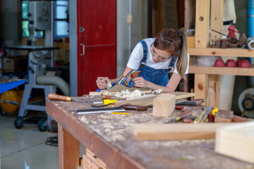 portrait of beautiful asian woman carpenter dealing with handicraft, woman has own business...