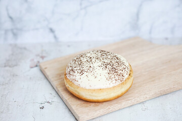 Tiramisu Doughnut Delicious appetizing cake, cream on a white glaze