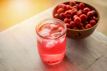 Glass of sour cherry juice with fresh red cherries, Cherry juice, on wood background, red drink, High vitamin C and antioxidant fruits.