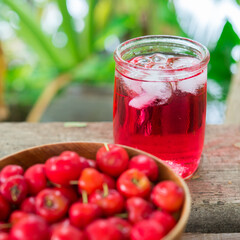 Glass of sour cherry juice with fresh red cherries, Cherry juice, on wood background, red drink, High vitamin C and antioxidant fruits.