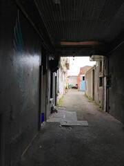 View down a dark industrial alleyway in central Invercargill, New Zealand.