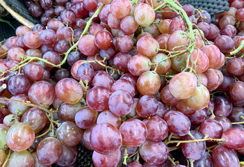 A pile of fresh red grapes in the supermarket