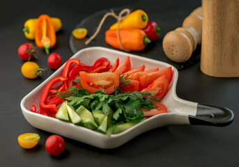 fresh vegetables on a serving plate on a dark background