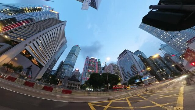 Twilight to night motion time-lapse of chaotic traffic on Connaught Road Central, Heritage Historical Building in Hong Kong