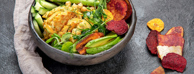 Vegan buddha bowl. Bowl with  vegetables, Zucchini fritters and vegetables chips.