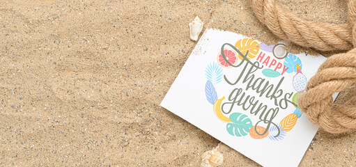 Greeting card with text HAPPY THANKSGIVING and rope on beach sand with space for text