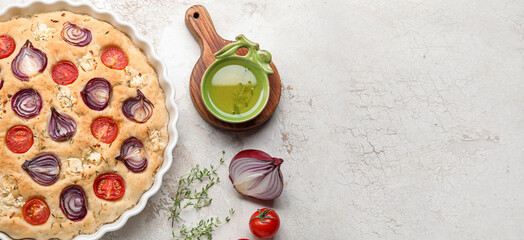 Baking dish with tasty Italian focaccia and ingredients on light background with space for text