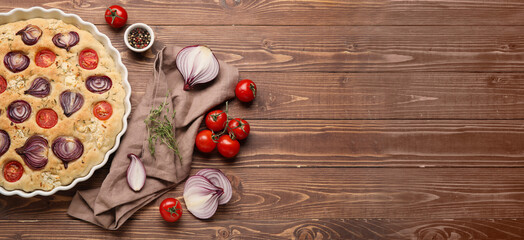 Composition with tasty Italian focaccia and ingredients on wooden background with space for text, top view