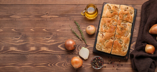 Composition with tasty Italian focaccia and  ingredients on wooden background with space for text,...