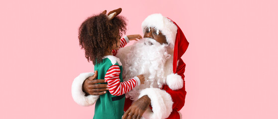 Cute little elf with Santa Claus on pink background