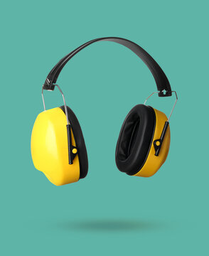 Modern hearing protectors on green background