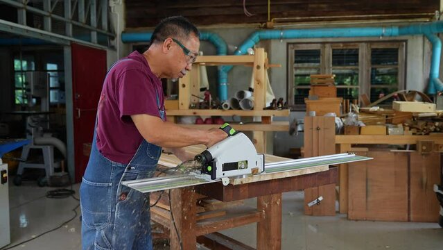 Miter saw with a large metal blade in the hands of a carpenter. Working tool for sawing wooden planks.the sawing process. Labor protection and safety rules for the use of power tools.Building a house.