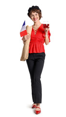 Young woman with flag of France, wine and baguettes on white background