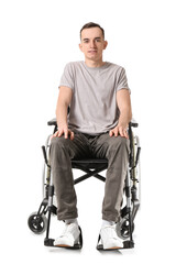 Fototapeta na wymiar Young man in wheelchair isolated on white
