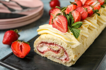 Board with tasty strawberry roll cake on color background, closeup