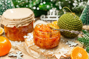 Orange marmalade or orange jam in glass jars. Sweet confiture with festive Christmas decor