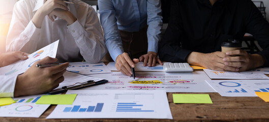 Financial analysts analyze business financial reports on a digital tablet planning investment...