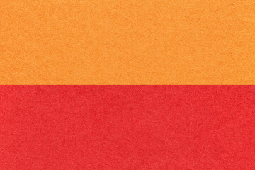 Fototapeta premium Texture of craft bright orange and red paper background, half two colors, macro. Vintage dense ruby cardboard.