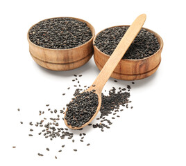 Wooden spoon and bowls of black sesame seeds on white background