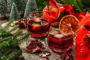 Obraz na płótnie Canvas Non-alcoholic cocktail with fruits syrup and ice. Christmas traditional decor, New Year arrangement