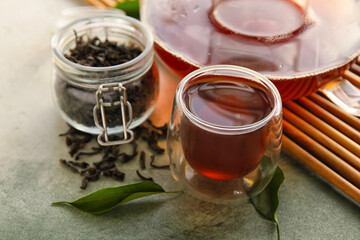Glass cup of black tea on table, closeup