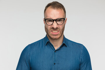 casual man is frowning at the camera