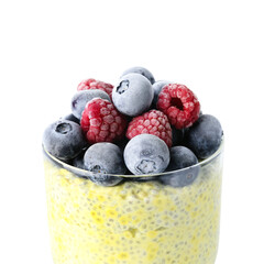 Glass of tasty chia seed pudding with berries on white background, closeup