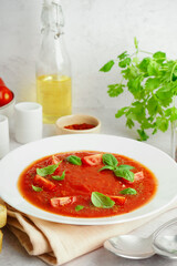 Plate with tasty tomato soup on table, closeup