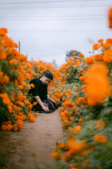 lady picking marigold flowers