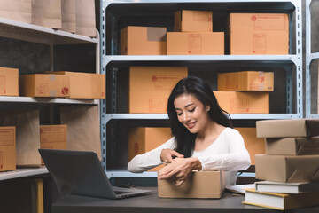 young beautiful woman packing a parcel order on online shopping for delivery to customer. Young women with new business about online shopping in home office and small store.