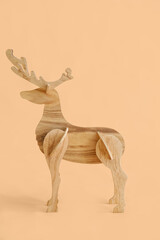 Decorative wooden reindeer on beige background