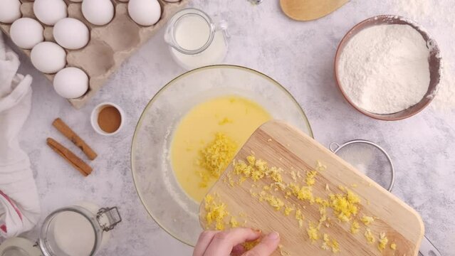 Pour lemon zest into a plate with dough, top view, step by step recipe