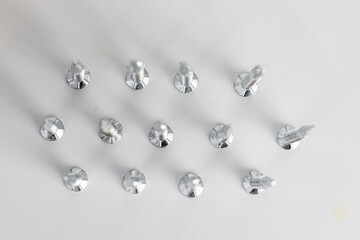 Tapping screws made of steel on gray background, metal screw, iron screw, chrome screw, screws as a background, wood screw, concept industry. copy space for text.