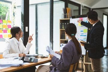 Business adviser explaining business plan strategy on flipchart to colleagues, male coach or adviser giving presentation at briefing, reporting about results or growing sales
