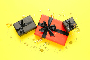 Gift boxes on yellow background. Black Friday sale