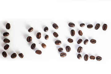 Roasted coffee Beans on white background. Coffee beans close up. Coffee grounds. Freshly roasted coffee beans. Image of a drink made from granules, derived from coffee plant. Copy space for text.