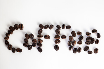 Coffee Beans on white background. Coffee grounds. Freshly roasted coffee beans. Image of a drink made from granules, derived from coffee plant. Copy space for text.