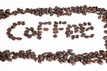 Coffee Beans on white background. Coffee grounds. Freshly roasted coffee beans. Image of a drink made from granules, derived from coffee plant. Copy space for text.