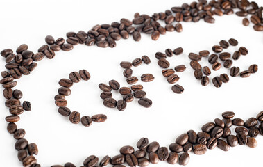 Coffee Beans on white background. Coffee grounds. Freshly roasted coffee beans. Image of a drink made from granules, derived from coffee plant. Copy space for text.